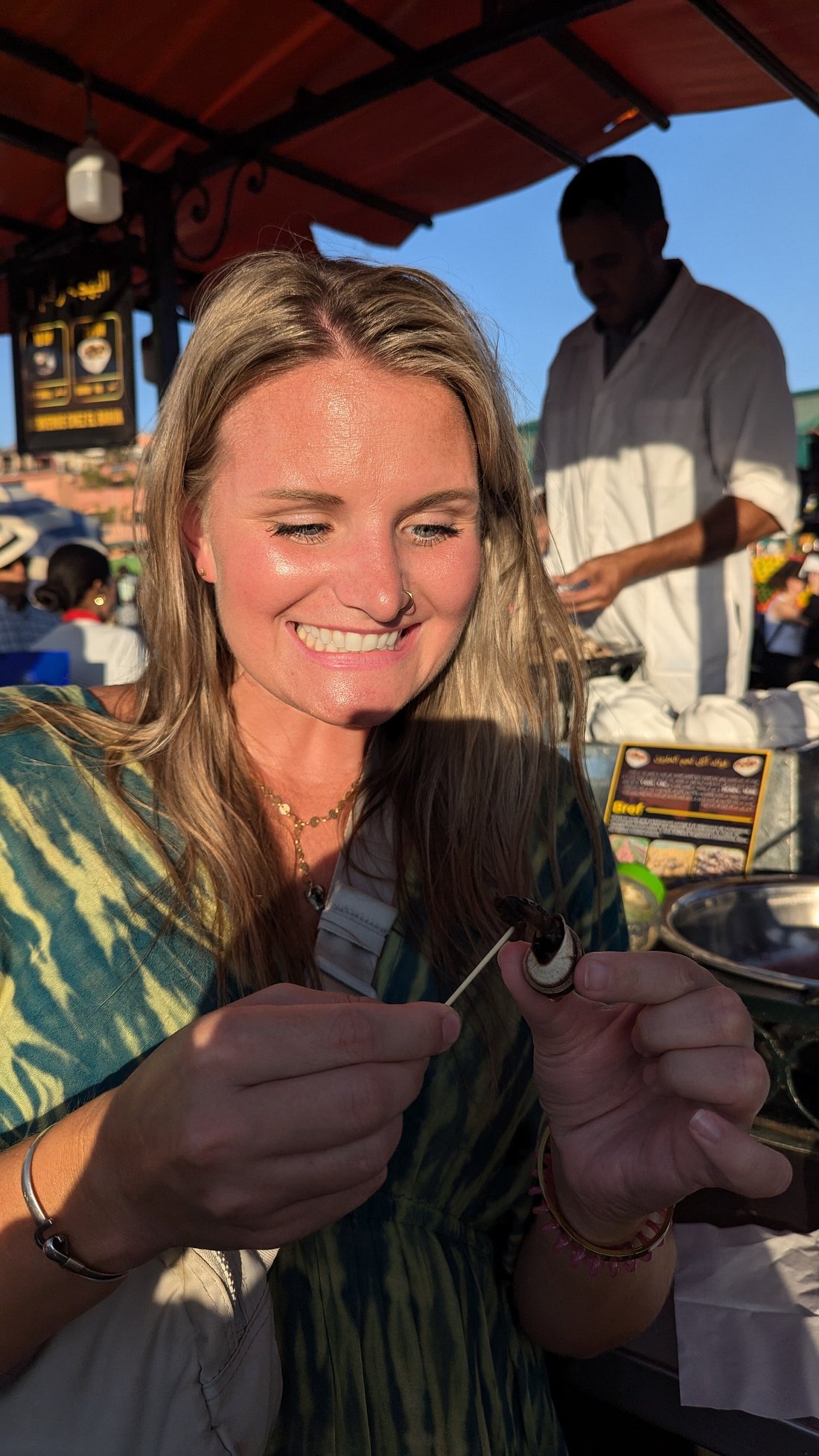 Authentic Marrakech Food Tour - guest trying snails in Jemaa el Fna square Marrakech
